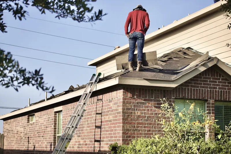 Professional roofer working on a residential roof in Harbor Shores